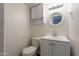 Small bathroom with white vanity, standard toilet, vanity mirror, and updated sink faucet at 2103 N Silverton St, Mesa, AZ 85203