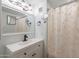 Bright bathroom with white vanity, large mirror, and shower with a patterned curtain at 2103 N Silverton St, Mesa, AZ 85203