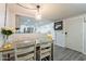 Inviting dining area adjacent to an updated kitchen with modern decor and great lighting at 2103 N Silverton St, Mesa, AZ 85203