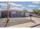 Charming single-story home with a gravel front yard and well-defined landscape features under a partly cloudy sky at 2103 N Silverton St, Mesa, AZ 85203