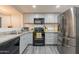 Modern kitchen with stainless steel appliances, granite countertops, and an efficient layout for easy cooking at 2103 N Silverton St, Mesa, AZ 85203