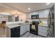 Well-appointed kitchen featuring stainless steel appliances, gray cabinets, and an efficient layout for cooking at 2103 N Silverton St, Mesa, AZ 85203