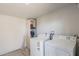 Functional laundry room with modern washer and dryer units, offering convenience for laundry tasks at 2103 N Silverton St, Mesa, AZ 85203
