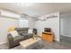 Comfortable living room with a plush gray sofa, modern shelves, and stylish décor, offering a cozy retreat at 2103 N Silverton St, Mesa, AZ 85203
