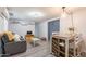Cozy living room featuring wood-look flooring, comfortable seating, and modern lighting fixtures at 2103 N Silverton St, Mesa, AZ 85203