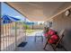 Covered patio with comfortable seating, offering a relaxing outdoor space for leisure and entertainment at 2103 N Silverton St, Mesa, AZ 85203