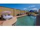 Pool area with a cabana, chairs, privacy wall, and an inviting atmosphere for outdoor relaxation and entertainment at 2103 N Silverton St, Mesa, AZ 85203