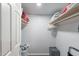 Organized walk-in closet with shelves for storage and plenty of room for organizing clothes and accessories at 2103 N Silverton St, Mesa, AZ 85203