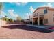 Backyard featuring a gravel area, block fence, patio, and a view of the home's exterior at 2130 N Cypress Point N Way, Casa Grande, AZ 85122