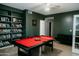 Spacious game room with a bright red pool table, built-in bookshelves, and comfortable seating at 2130 N Cypress Point N Way, Casa Grande, AZ 85122