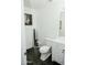 Contemporary half bathroom featuring dark tile floors, white wainscoting and vanity with gold fixtures at 2130 N Cypress Point N Way, Casa Grande, AZ 85122