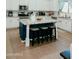 Kitchen boasts an island with granite countertops, barstool seating, and white cabinetry at 2130 N Cypress Point N Way, Casa Grande, AZ 85122