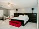 Spacious main bedroom with a ceiling fan, shuttered windows and a red ottoman at 2130 N Cypress Point N Way, Casa Grande, AZ 85122