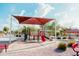Community playground with shade canopy, slide, and nearby seating at 2130 N Cypress Point N Way, Casa Grande, AZ 85122