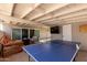 Relaxing covered patio featuring a ping pong table and an outdoor entertainment space at 2210 E Birchwood Ave, Mesa, AZ 85204