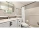 Well-lit bathroom featuring a vanity with black hardware and a shower with white tiles at 2210 E Birchwood Ave, Mesa, AZ 85204