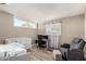Versatile bedroom with a crib, desk setup, and comfortable seating at 2210 E Birchwood Ave, Mesa, AZ 85204
