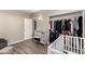 Neutral room features a dresser, crib, and organized closet space at 2210 E Birchwood Ave, Mesa, AZ 85204