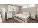 Cozy bedroom featuring a neutral palette, natural light, and wood-look flooring at 2210 E Birchwood Ave, Mesa, AZ 85204