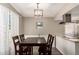 Cozy dining area with modern lighting fixture and bright natural light at 2210 E Birchwood Ave, Mesa, AZ 85204