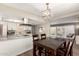 Bright kitchen with white cabinets, stainless steel appliances, and an adjacent dining area at 2210 E Birchwood Ave, Mesa, AZ 85204