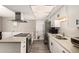 Clean updated kitchen featuring white cabinets, stainless steel appliances, and granite counters at 2210 E Birchwood Ave, Mesa, AZ 85204