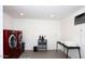 Spacious laundry room with side-by-side red washer and dryer at 2210 E Birchwood Ave, Mesa, AZ 85204