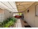 Inviting covered patio with string lights, ample seating, and lush greenery at 2210 E Birchwood Ave, Mesa, AZ 85204
