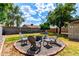 Backyard sitting area with mature trees, lush green grass, and a beautiful sky at 2215 W Straford Dr, Chandler, AZ 85224