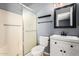 This bathroom has a shower, toilet, a vanity with a black faucet and a framed mirror at 2215 W Straford Dr, Chandler, AZ 85224