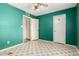 The bedroom offers green walls, neutral flooring, and two closet doors at 2215 W Straford Dr, Chandler, AZ 85224