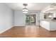 Open dining area with wood-look floors, backyard access, and seamlessly connected to the kitchen at 2215 W Straford Dr, Chandler, AZ 85224