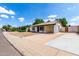 Street view of a single-story home with low maintenance desert rock landscaping and a spacious driveway at 2215 W Straford Dr, Chandler, AZ 85224