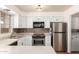 Bright kitchen featuring stainless steel appliances, white cabinets, tile backsplash and a garden view window at 2215 W Straford Dr, Chandler, AZ 85224