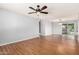 Large open living area with wood-look floors, stylish lighting, and sliding door access to backyard at 2215 W Straford Dr, Chandler, AZ 85224
