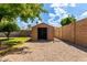 Exterior of a shed offering additional storage space in the backyard, surrounded by gravel at 2215 W Straford Dr, Chandler, AZ 85224