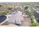 Aerial view of house in a desert neighborhood with a pool, backyard, solar panels, and a circular driveway at 2336 W Laredo Ln, Phoenix, AZ 85085