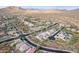 Aerial view of a desert neighborhood with homes, roads, and natural landscape, and mountain views at 2336 W Laredo Ln, Phoenix, AZ 85085