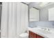 Bathroom featuring a mirror, sink, toilet, and shower with white curtain at 2336 W Laredo Ln, Phoenix, AZ 85085
