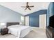 Bedroom with a ceiling fan, blue accent walls, and natural light from the window at 2336 W Laredo Ln, Phoenix, AZ 85085