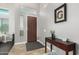 Welcoming entryway with tile flooring, dark wood door, and console table at 2336 W Laredo Ln, Phoenix, AZ 85085