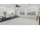 Spacious home gym featuring cardio equipment, weight machines, and ample natural light at 2336 W Laredo Ln, Phoenix, AZ 85085