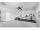 Spacious home gym with a ceiling fan, fitness equipment, and a neutral color scheme at 2336 W Laredo Ln, Phoenix, AZ 85085