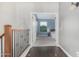 Hallway with hardwood floor and leading to a bedroom with blue walls and a window at 2336 W Laredo Ln, Phoenix, AZ 85085