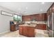 Elegant kitchen features an island, granite countertops, stainless steel appliances, and ample cabinet space at 2336 W Laredo Ln, Phoenix, AZ 85085