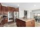 Beautiful kitchen equipped with stainless appliances, double oven, and an island with granite countertops at 2336 W Laredo Ln, Phoenix, AZ 85085