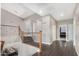 Well-lit landing with wood floors, iron railing, and a view of the dining room below at 2336 W Laredo Ln, Phoenix, AZ 85085