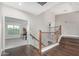 Open landing featuring wood floors, wood and iron railing, and a view into another room at 2336 W Laredo Ln, Phoenix, AZ 85085