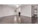 Spacious bedroom with wood floors, ceiling fan, and ensuite bathroom entrance at 2547 E Vermont Dr, Gilbert, AZ 85295