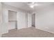 Bedroom featuring carpet flooring, ceiling fan, closet, and white door with access to the bathroom at 2547 E Vermont Dr, Gilbert, AZ 85295